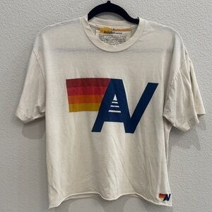 Aviator Nation Cream Short-Sleeve Tee with Navy AV and Red-Orange-Yellow Stripes